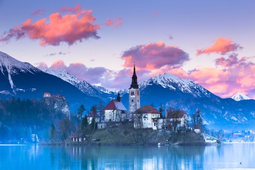 Sunset view of Julian Alps, Lake Bled with St. Marys Church of the Assumption on the small island; Bled, Slovenia, Europe.