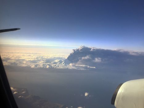 UNITED STATES, Aleutian Islands: Pavlof Volcano on Aleutian Islands chain sends ash plume in to the air on March 27, 2016. The photo was taken by a passenger of a flight out of Dutch Harbor airport. The ash plume is around 37,000 feet high and trails some 400 miles to the northeast over the Alaskan interior. Aviation alerts were up in the region.