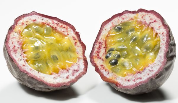 Passion Fruit Cut in Half close up on white background.