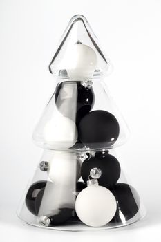 glass christmas tree with black and white balls in it, isolated on white background