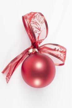 Red christmas ball with ribbon bow, isolated on white background