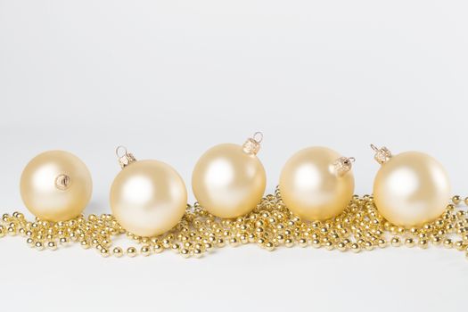 Golden, yellow Christmas balls, isolated on white background