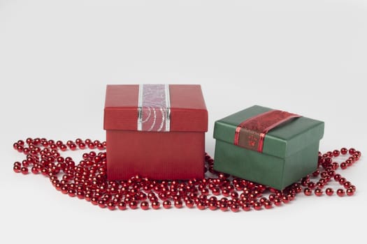 Two presents, red and green, with ribbons, isolated on white background