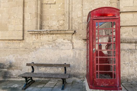 Traditional red phone boot and wooden bench