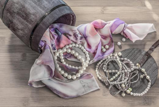 Still life details, scarf and pearls in retro vintage wooden box