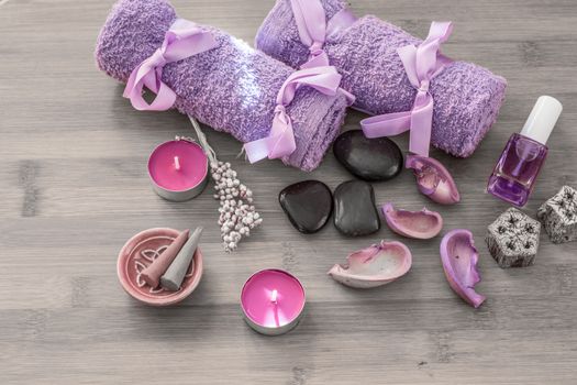 Spa concept. Lavender oil, lavender flowers and bath white and purple towels