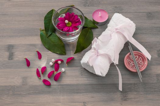 Spa concept.Spa concept.flowers,candle and bath white towels on wooden background.