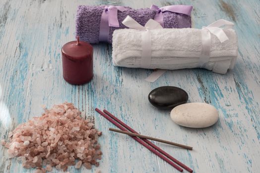 Spa concept. candles, aromatic salt, and bath  towels on wooden background