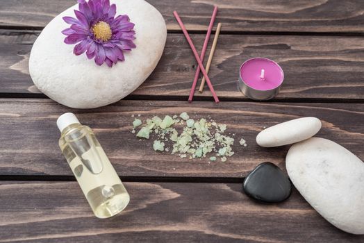 Spa concept. lavander oil flowers,candle, aromatic salt, and stone on wooden background