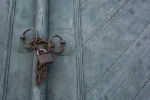 Old padlock on a blue wooden door