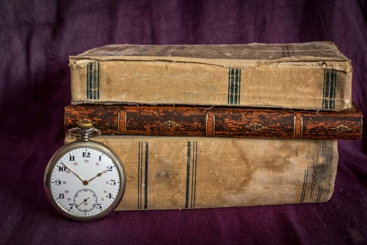 Vintage  still life with pocket watch, and old book