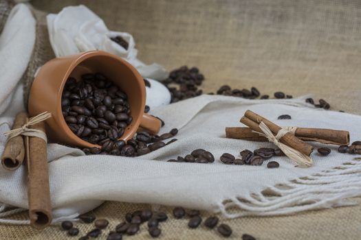 A Cup of coffee with cinnamon and coffee beans