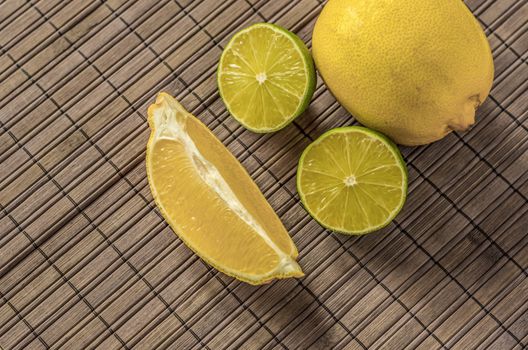 Lemon and limes,sliced on a woodenboard