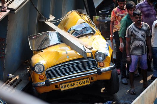 INDIA, Kolkata: Indian rescue workers and volunteers try to free people trapped under the wreckage of a collapsed flyover bridge in Kolkata on March 31, 2016. At least 14 people were killed and dozens more injured when a flyover collapsed in a busy Indian city on March 31, an official said, as emergency workers battled to rescue people trapped under the rubble.