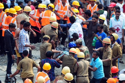 INDIA, Kolkata: Indian rescue workers and volunteers carry away a body next to the wreckage of a collapsed flyover bridge in Kolkata on March 31, 2016. At least 14 people were killed and dozens more injured when a flyover collapsed in a busy Indian city on March 31, an official said, as emergency workers battled to rescue people trapped under the rubble.