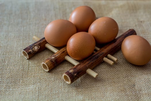Chicken eggs on bamboo pad