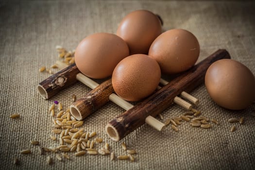 Chicken eggs and wheat on bamboo pad