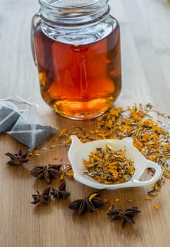 Tea, dried cinnamon, vegan cookies ,orange and anise on wooden background