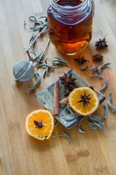 Tea,tea stainer, dried cinnamon, vegan cookies and anise on wooden background