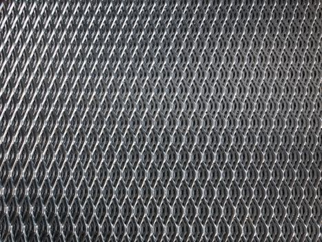 Shiny, galvanised industrial steel grid for use as background.