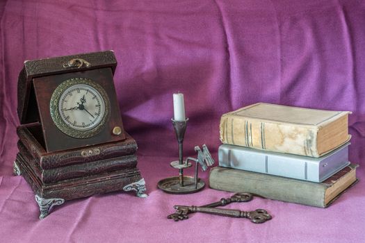 Retro still life with clock,books and candle