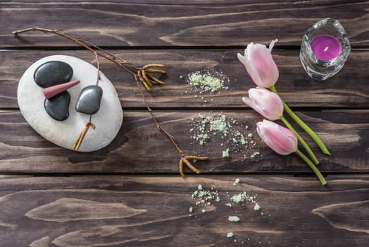 Spa concept. flowers,candles, aromatic salt on wooden background