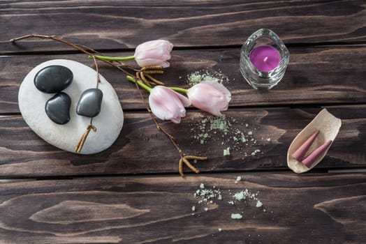 Spa concept. flowers,candles, aromatic salt on wooden background