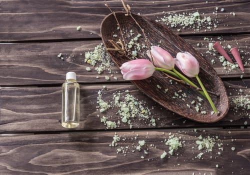 Spa concept. flowers,lavender oil, aromatic salt,on wooden background
