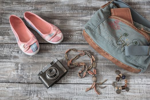 Vintage still life of random objects of modern woman on wooden board