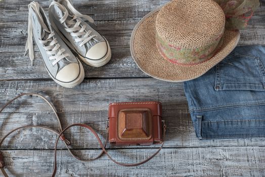 Vintage still life of random objects of modern woman on wooden board