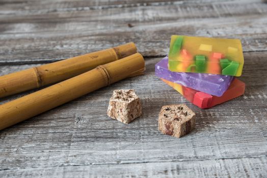 Spa concept. aromatic soaps and bamboo sticks on wooden background