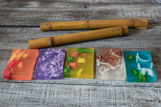 Spa concept. aromatic soaps and bamboo sticks on wooden background