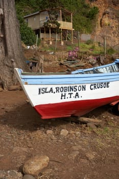 Colourful fishing boat on the shore on Robinson Crusoe Island, one of three main islands making up the Juan Fernandez Islands some 400 miles off the coast of Chile.