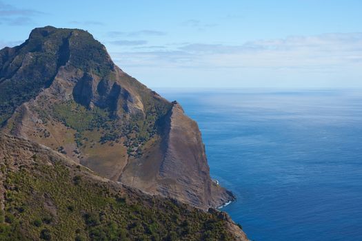 Panoramic view of the coast of volcanic landscape of Robinson Crusoe Island, one of three main islands making up the Juan Fernandez Islands some 400 miles off the coast of Chile.