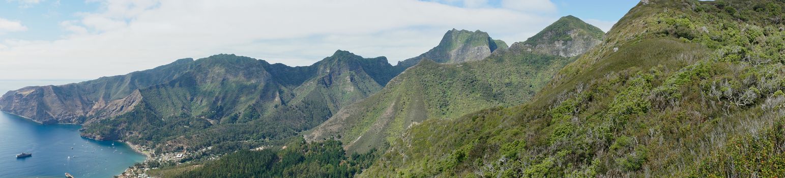 Panoramic view of the coast of volcanic landscape of Robinson Crusoe Island, one of three main islands making up the Juan Fernandez Islands some 400 miles off the coast of Chile.