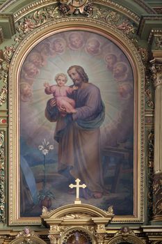 Saint Joseph holding child Jesus altarpiece in the Basilica of the Sacred Heart of Jesus in Zagreb, Croatia