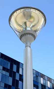 modern street lamp on background of blue sky and modern buildings