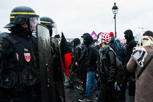 FRANCE, Paris: Protesters face police officers as thousands march against the French government's planned labor law reforms on March 31, 2016 in Paris. France faced fresh protests over labour reforms just a day after the beleaguered government of Presiden