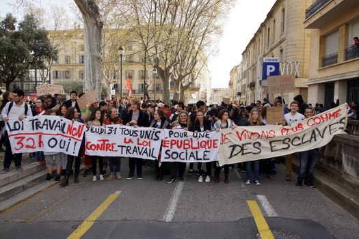 FRANCE, Nîmes: Protesters march holding banners as thousands of protesters march during a demonstration against the French government's planned labour law reforms on March 31, 2016 in Nîmes. France faced fresh protests over labour reforms just a day after the beleaguered government of President Francois Hollande was forced into an embarrassing U-turn over constitutional changes.