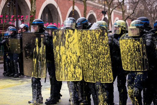 FRANCE, Paris: French riot police officers with yellow paint on their shields stand in line as thousands demonstrate against the French government's planned labour law reforms on March 31, 2016 in Paris. France faced fresh protests over labour reforms just a day after the beleaguered government of President Francois Hollande was forced into an embarrassing U-turn over constitutional changes.