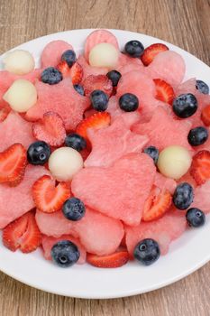 salad of blueberries, watermelon hearts, stars, balls of melon and strawberries