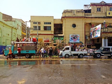 YANGON, MYANMAR - APRIL 16, 2013 :Day traffic moves easily past the water platforms during the Thingyan Water Festival in Yangon, Myanmar