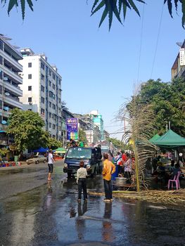 YANGON, MYANMAR - APRIL 16, 2013 :Day traffic moves easily past the water platforms during the Thingyan Water Festival in Yangon, Myanmar