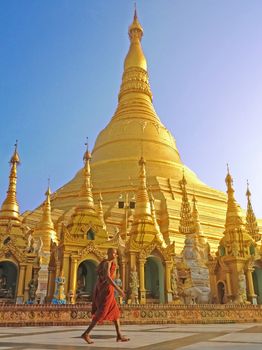 YANGON, MYANMAR - APRIL 15, 2013 : Buddhist monk walking in Shwedagon