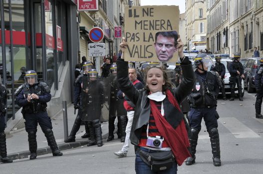 FRANCE, Marseille: A protester holds a sign reading 'He will not lead the Valls' (homonym for waltz in French) as thousands of protesters march during a demonstration against the French government's planned labour law reforms on March 31, 2016 in Marseille. France faced fresh protests over labour reforms just a day after the beleaguered government of President Francois Hollande was forced into an embarrassing U-turn over constitutional changes.