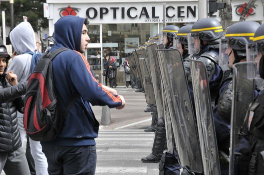 FRANCE, Marseille: A protester face the police as thousands of protesters march during a demonstration against the French government's planned labour law reforms on March 31, 2016 in Marseille. France faced fresh protests over labour reforms just a day after the beleaguered government of President Francois Hollande was forced into an embarrassing U-turn over constitutional changes.