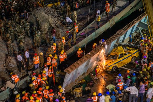 INDIA, Kolkata: Rescue workers and volunteers search for survivors of a bridge collapse that left at least 15 dead and dozens more injured in Kolkata, India on March 31, 2016.