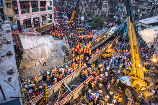 INDIA, Kolkata: Rescue workers and volunteers search for survivors of a bridge collapse that left at least 15 dead and dozens more injured in Kolkata, India on March 31, 2016.