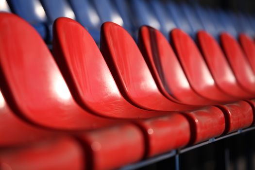 Red chairs bleachers in stadium close to