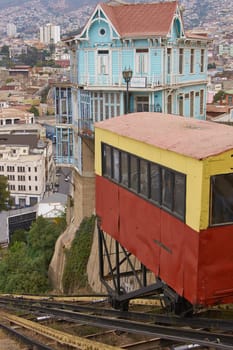 Carriage of the historic Ascensore Arttilleria travelling up a steep hillside in port city of Valparaiso in Chile .